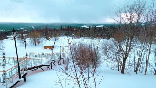 View of the chapel near the Belogorsky St. Nicholas Orthodox Missionary Monastery. Winter forest. The temple on the hill in winter. Russia, Perm Krai, Belaya Gora. 4K photo