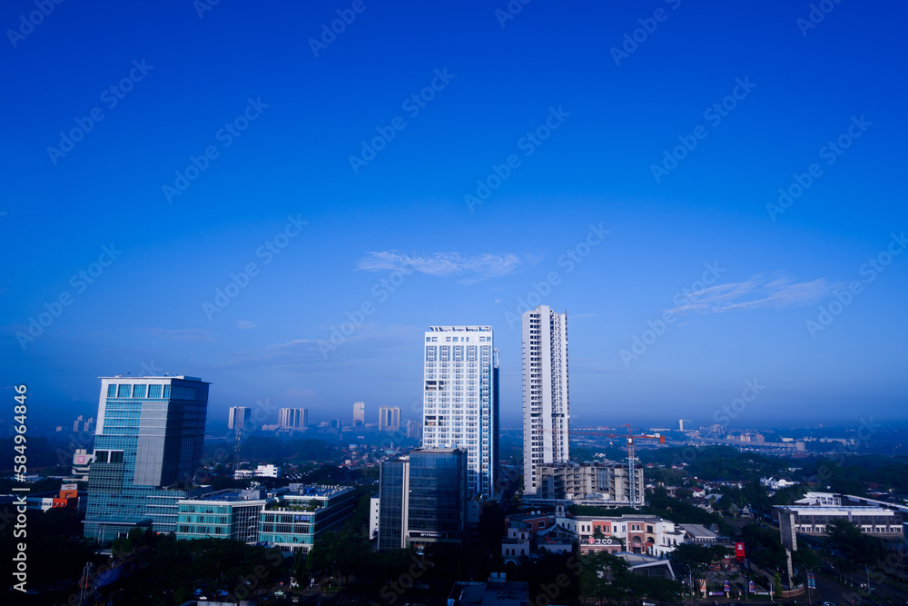 View of skyscrapers against blue sky background. 