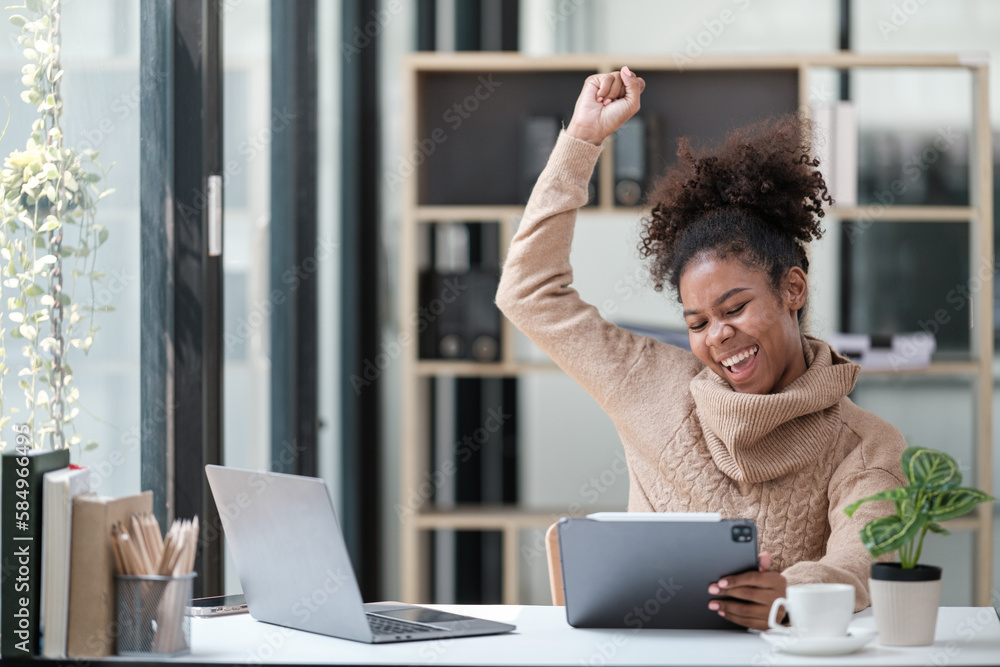 American African Woman working in the office with computer phone and Tablet. American African Woman working in the office with computer phone and Tablet.