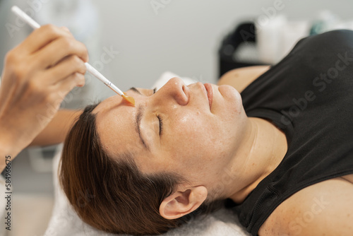 The face of a woman undergoing facial treatment

