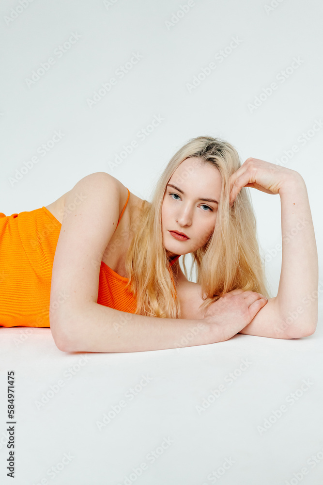 Serious female model lying on floor in studio Serious female model lying on floor in studio