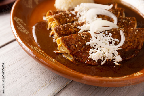 Chicken enmoladas. Also known as mole poblano enchiladas, they are a typical Mexican dish that is very popular in Mexico and the rest of the world. photo