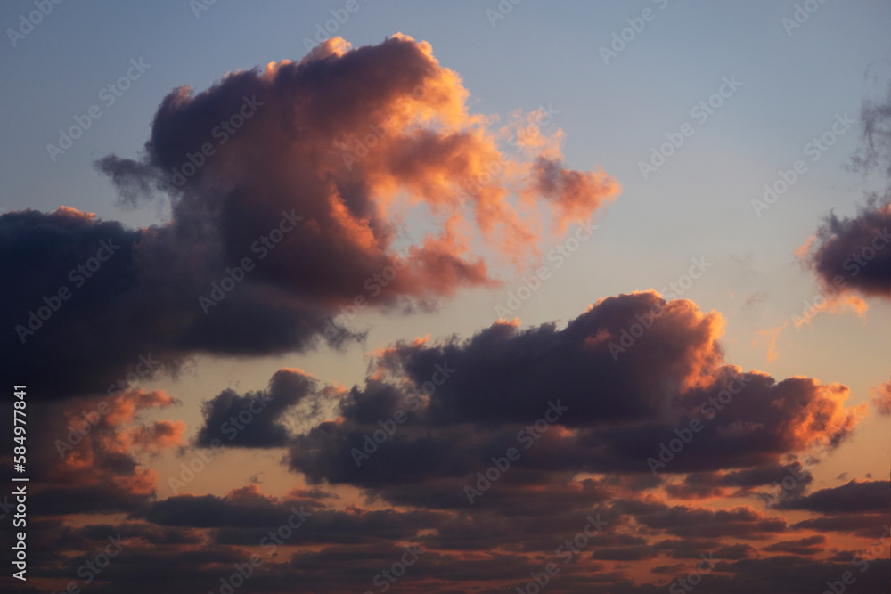 dramatic orange and dark blue clouds in the sky at sunset dramatic orange and dark blue clouds in the sky at sunset