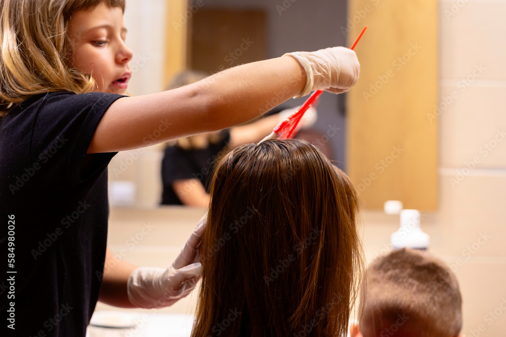 Girl dyeing her mother's hair Girl dyeing her mother's hair