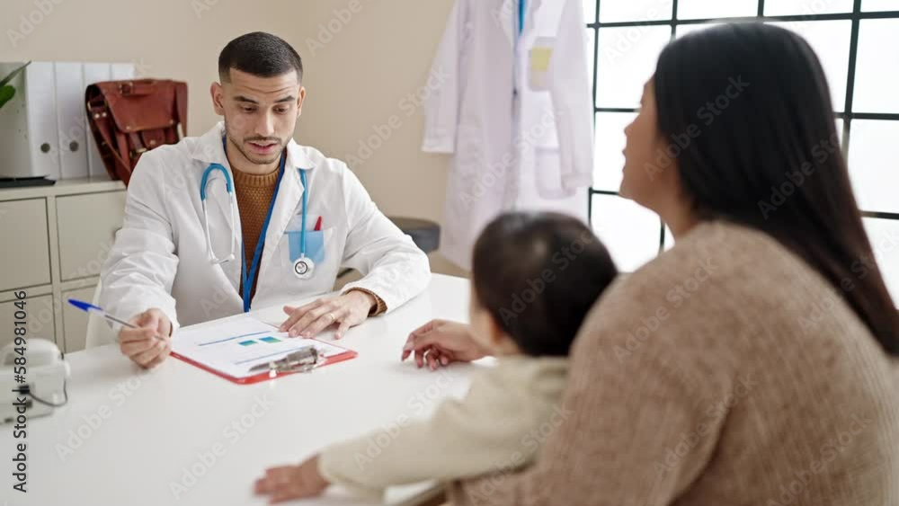 Couple and son smiling confident shake hands at clinic Couple and son smiling confident shake hands at clinic