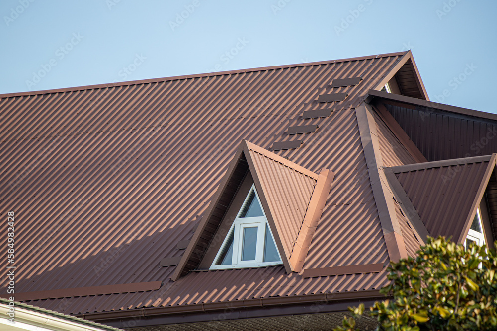 Roofs of houses with dormer windows against the sky. Urban architecture.