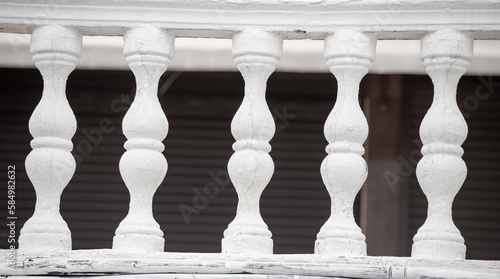 Row of white concrete balusters on the embankment close-up