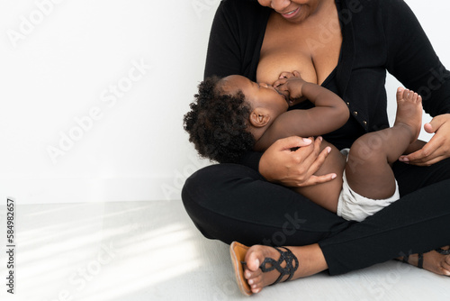 Mother and son nursing while sitting