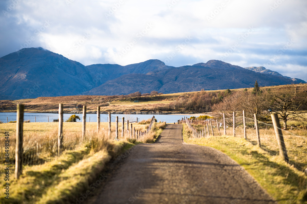 Road through rural Scottish Highlands at golden hour Road through rural Scottish Highlands at golden hour