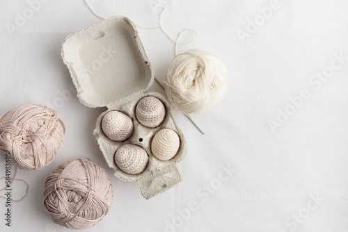 Canvas Print Set of cute easter crocheted eggs, pastel color in the eggbox