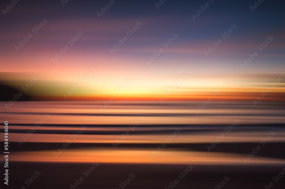 Abstract blurred seascape of colorful sunset over the ocean.