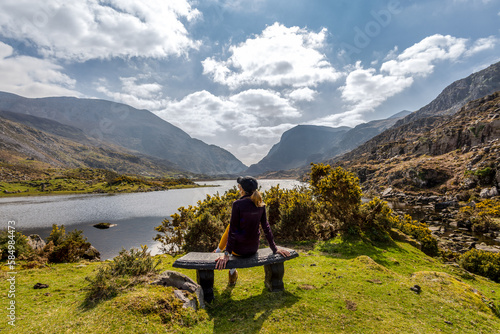 Woman admiring mountainous scenery at Gap of Dunloe Kerry mountains photo