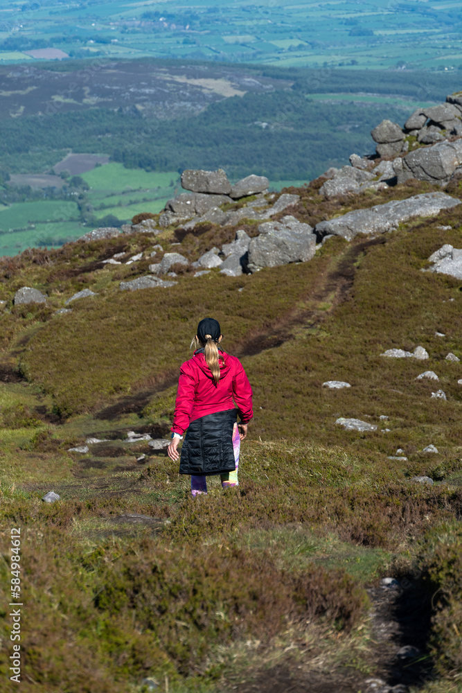 woman hiker going down small hill woman hiker going down small hill