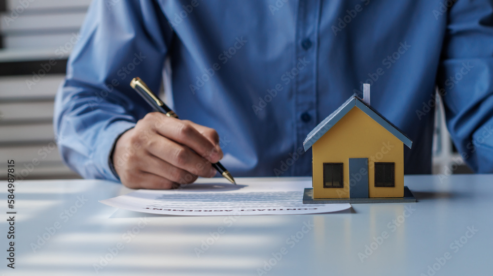 Fototapeta premium real estate agent Hand over the keys and the model house to the customer and the home insurance contract. home mortgage loan concept