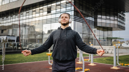 One man jump rope outdoor training young male exercise in the city