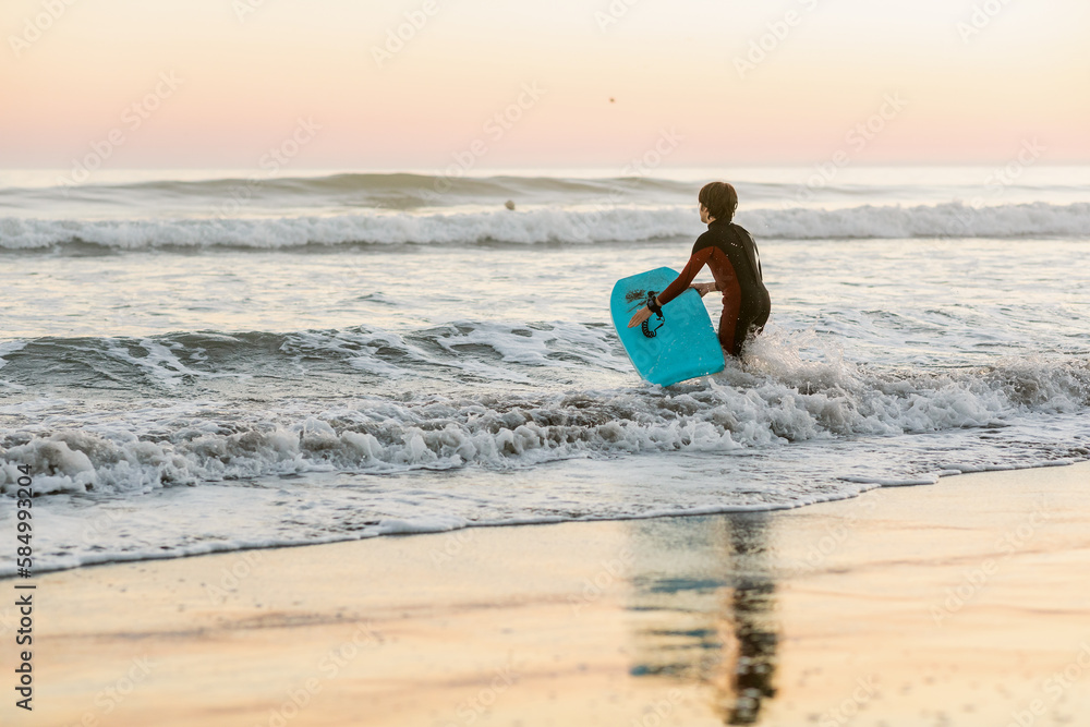 Teen boy enjoying surfing at the beach in California Teen boy enjoying surfing at the beach in California