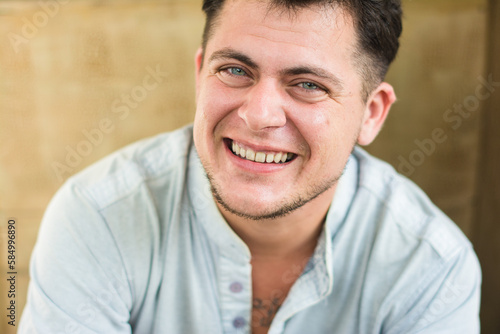Trans man with blue eyes portrait