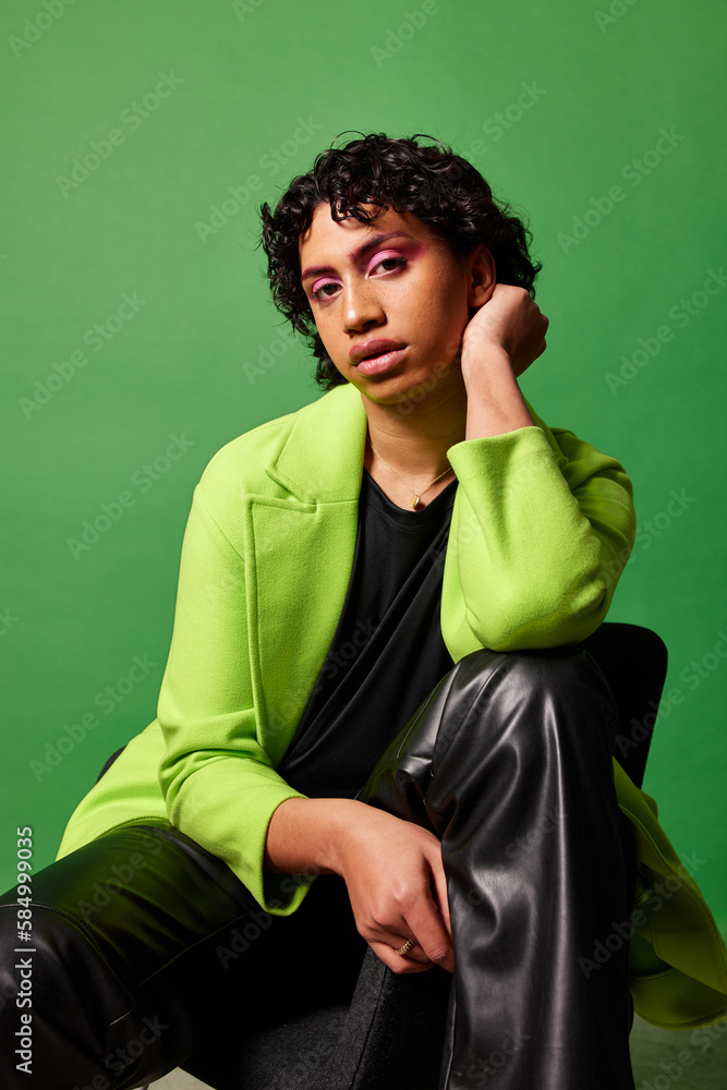 Extravagant man with makeup sitting on chair Extravagant man with makeup sitting on chair