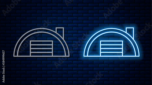 Glowing neon line Warehouse icon isolated on brick wall background. Vector