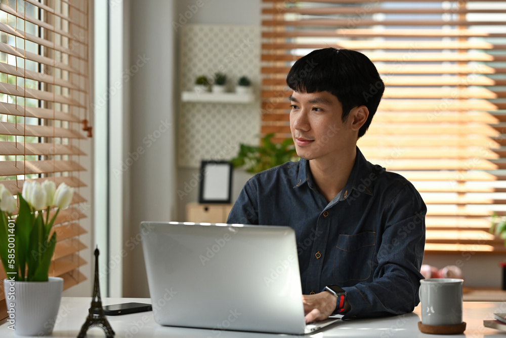 Handsome young businessman sitting in modern office and looking through window, thinking about startup, planning new projects. Handsome young businessman sitting in modern office and looking through window, thinking about startup, planning new projects.