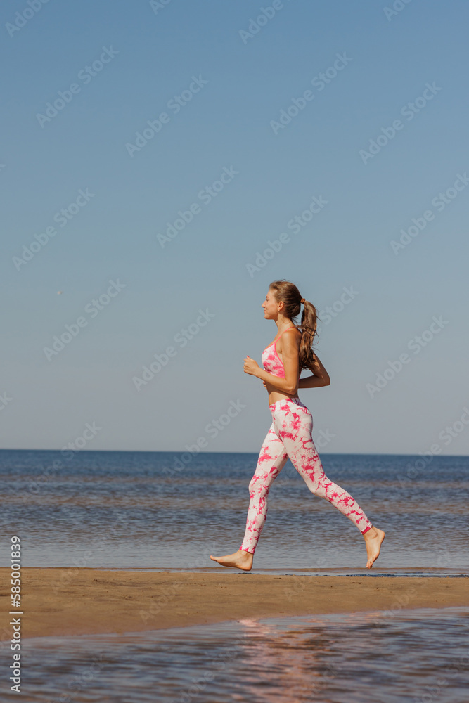 top view. athletic woman in sportswear runs sandy beach. sporty lady prepares for marathon do fitness, stretching, yoga outdoors. healthy lifestyle, strong muscles and back. confident female champion top view. athletic woman in sportswear runs sandy beach. sporty lady prepares for marathon do fitness, stretching, yoga outdoors. healthy lifestyle, strong muscles and back. confident female champion