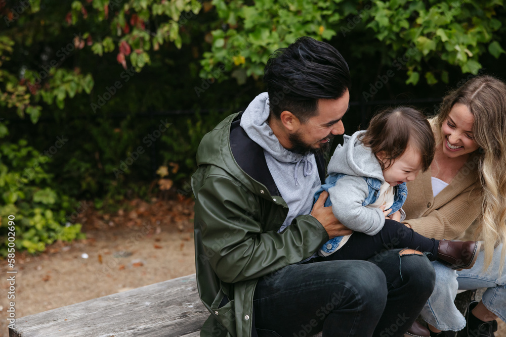 Family hugging and having fun together outside. Family hugging and having fun together outside.
