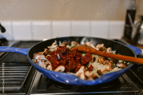 Cast iron skillet pan with ingredients  on stove photo