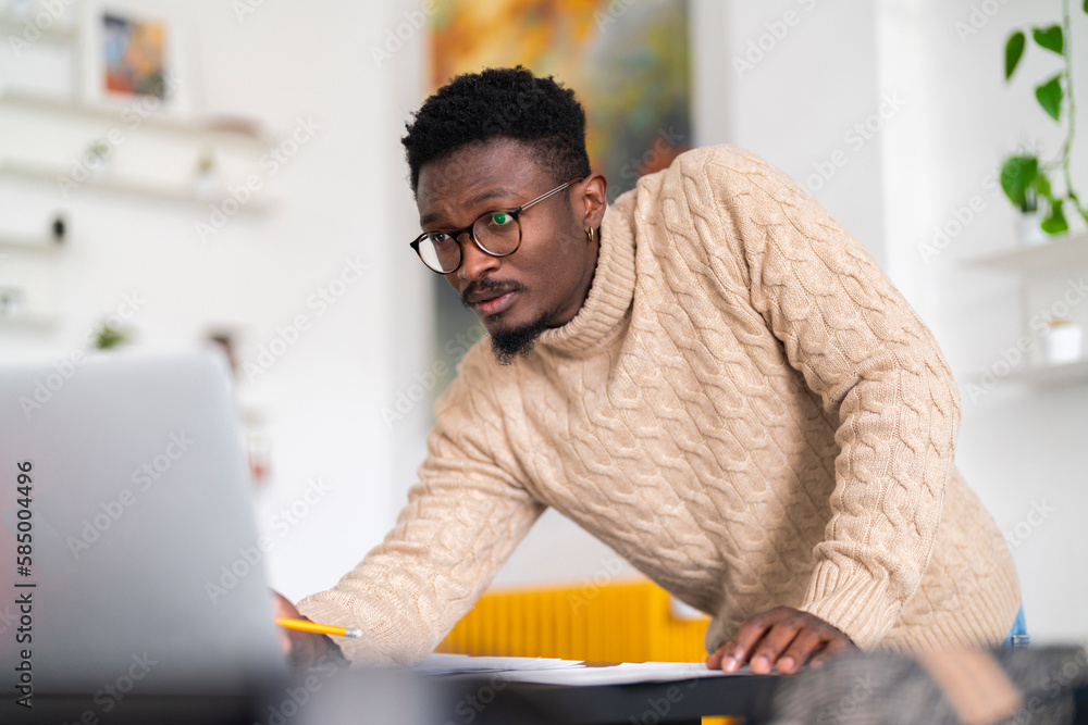 © Studio Marmellata/Stocksy - Serious man checking bills © Studio Marmellata/Stocksy - Serious man checking bills