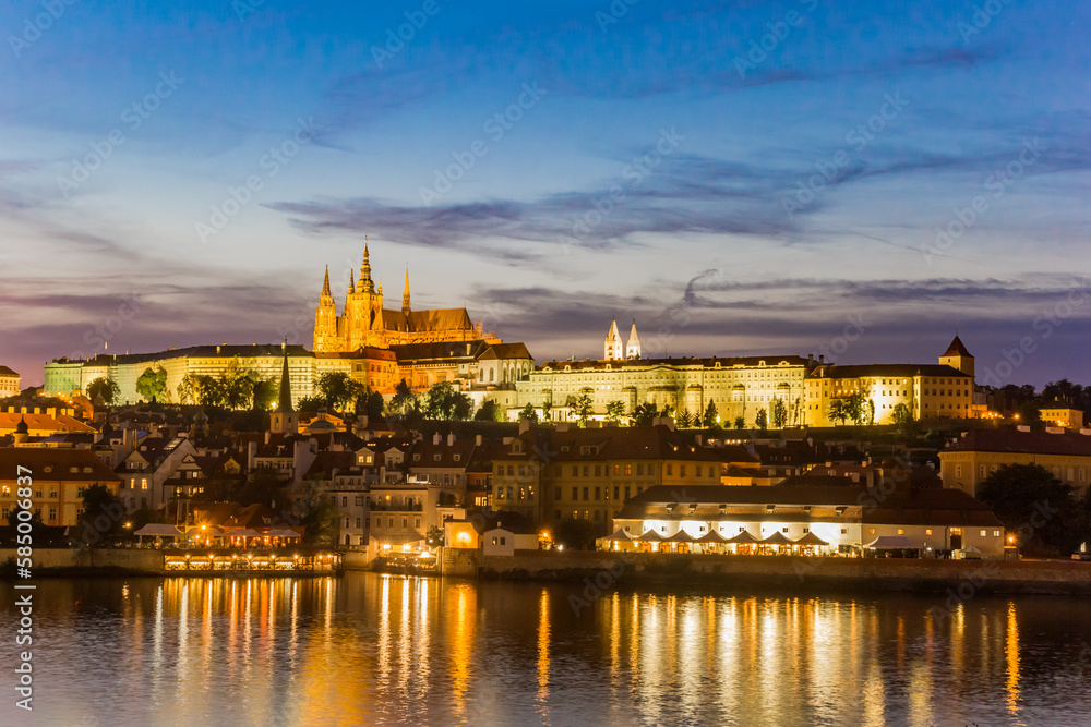 Night view over the river Moldau and the castle during blue hour in Prague, Czech Republic
