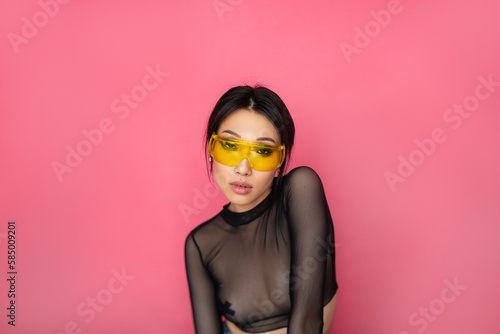 Stylish Asian woman in yellow sunglasses photo