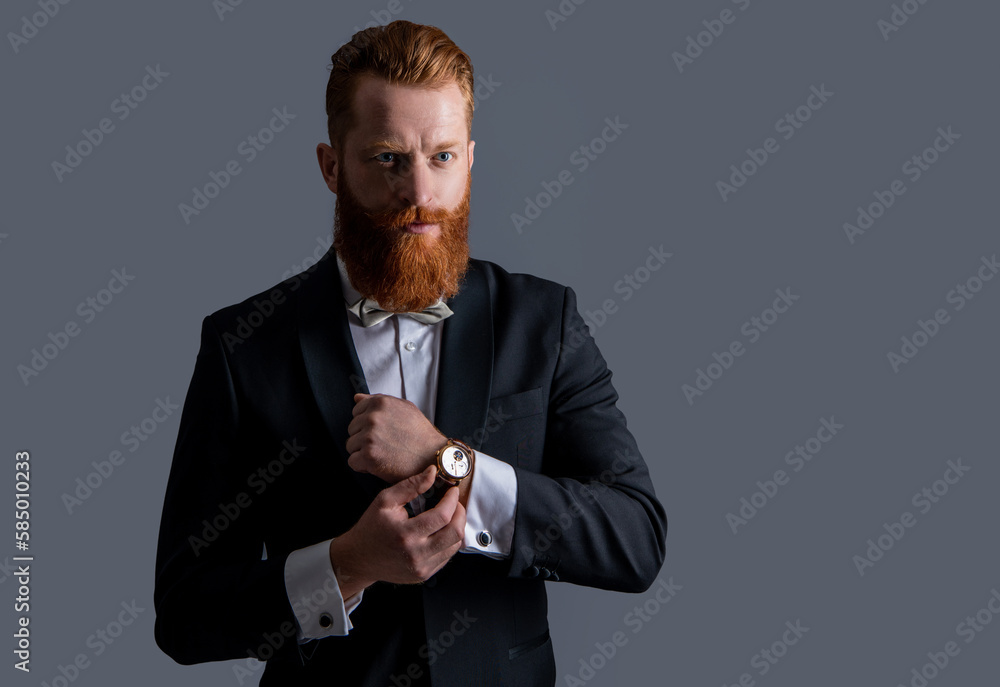 man wearing elegant wrist watch and tuxedo, copy space. tuxedo fashion. handsome bearded man man wearing elegant wrist watch and tuxedo, copy space. tuxedo fashion. handsome bearded man