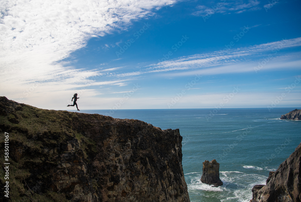 free woman runner running on the cliff. freedom and motivation free woman runner running on the cliff. freedom and motivation