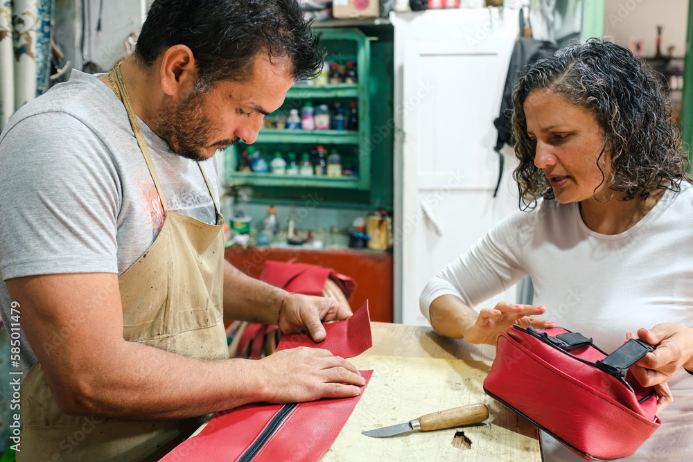 Craftsmen making a leather bag Craftsmen making a leather bag