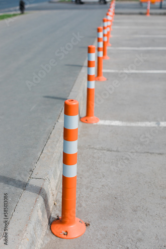 Orange fence on the street.  photo