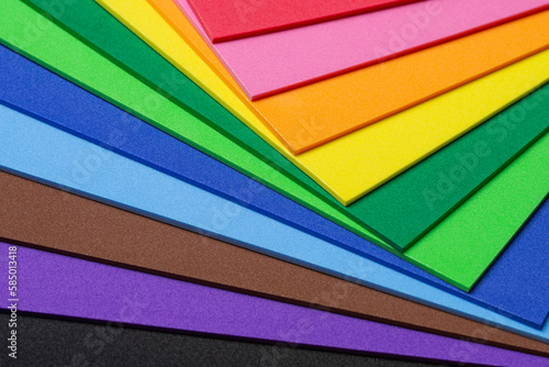 A mix of craft foam sheets in vibrant rainbow colors