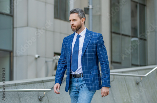 photo of business man walk with tie. business man outdoor. business man