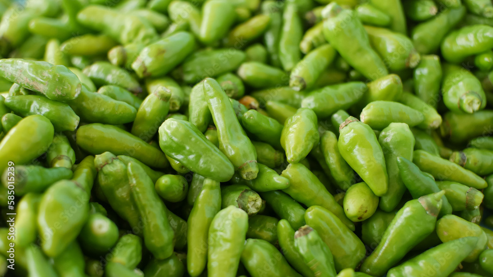 pile of green cayenne pepper pile of green cayenne pepper