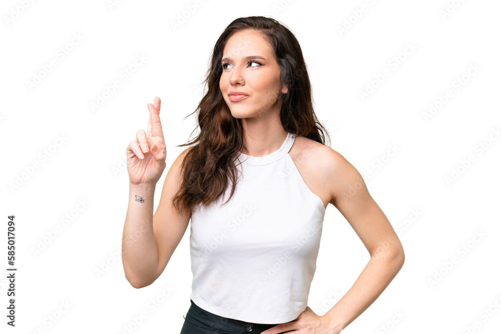 Young caucasian woman isolated over isolated background with fingers crossing and wishing the best Young caucasian woman isolated over isolated background with fingers crossing and wishing the best