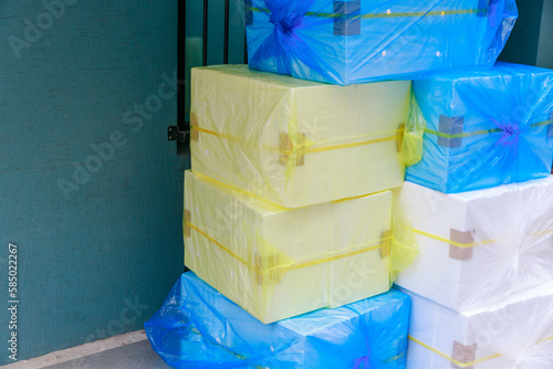 Styrofoam box wrapped in plastic next door to the store.