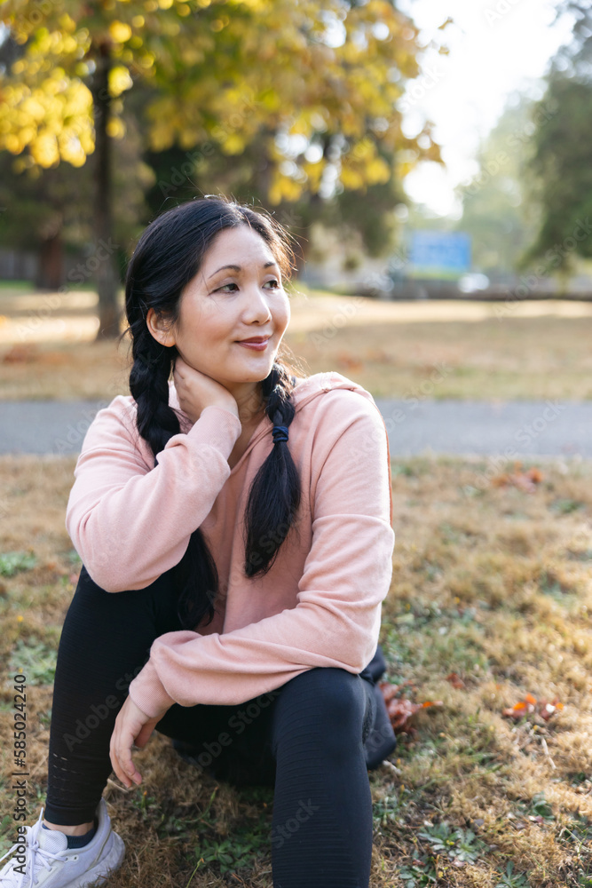 Thoughful, casual looking woman sitting outside in the park. Thoughful, casual looking woman sitting outside in the park.