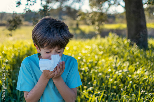 Little Boy Sneezing In The Field Because Of Allergy. Health Care.