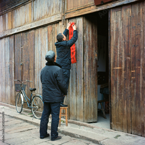 Two middle-aged men posted couplets