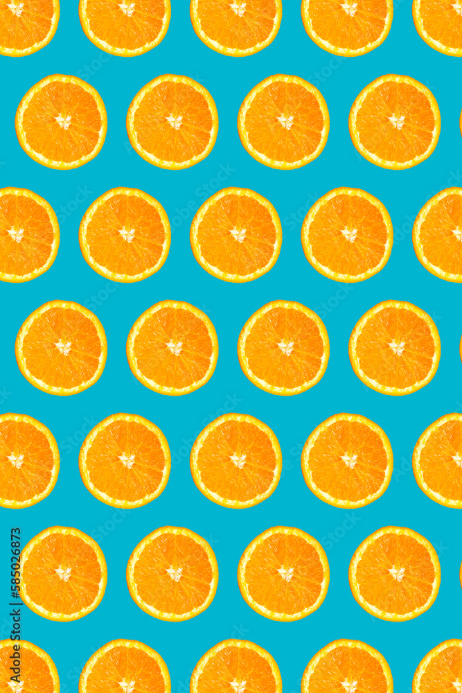 Uniform pattern of half slices of orange fruit on a light blue background. Colorful pattern of orange candies for design backgrounds Uniform pattern of half slices of orange fruit on a light blue background. Colorful pattern of orange candies for design backgrounds
