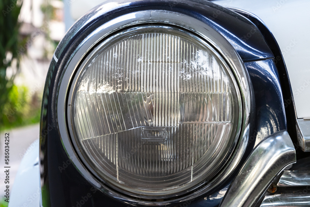 Classic round headlight of an old timer car. Close up photo