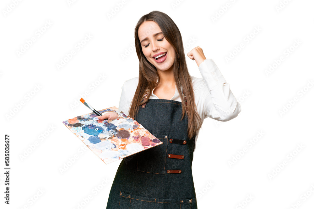 Young artist woman holding a palette over isolated chroma key background celebrating a victory Young artist woman holding a palette over isolated chroma key background celebrating a victory