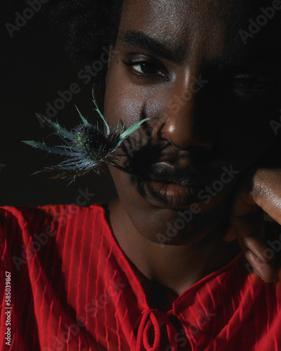 Black trendy woman sullenly Looking At Camera with a thorn in her lips photo