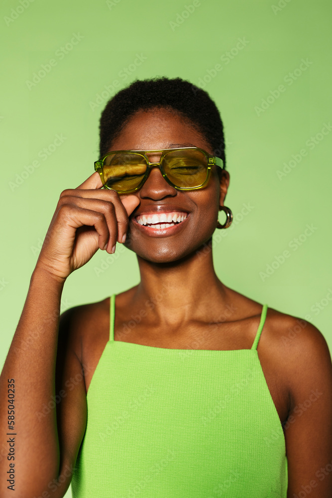 Cheerful woman standing in green wall Cheerful woman standing in green wall