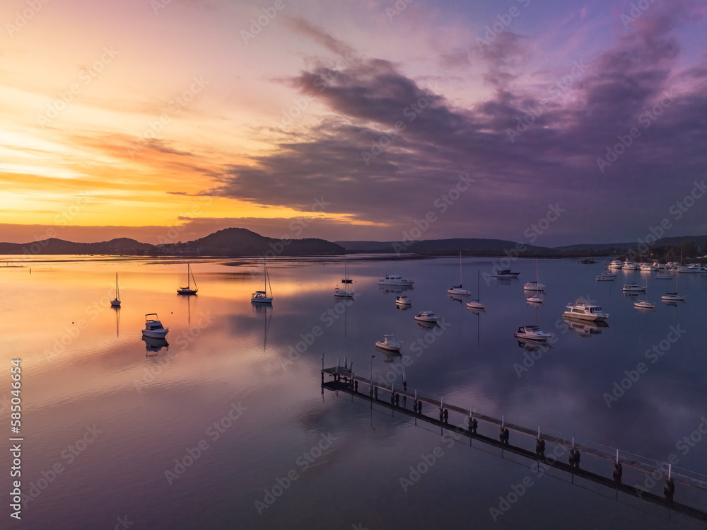 Fototapeta premium Aerial sunrise waterscape with boats and high cloud