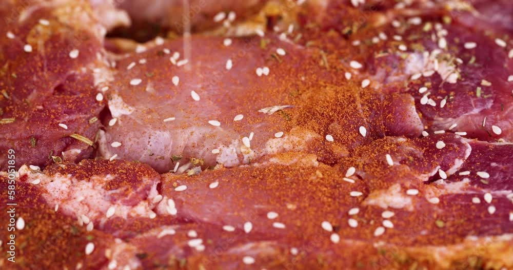 Sprinkle marinated pork meat with sesame spices, preparing pork neck meat for barbecue Sprinkle marinated pork meat with sesame spices, preparing pork neck meat for barbecue
