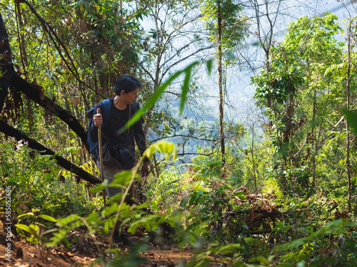 Solo backpacking in tropical forest on mountain trail © TongTa